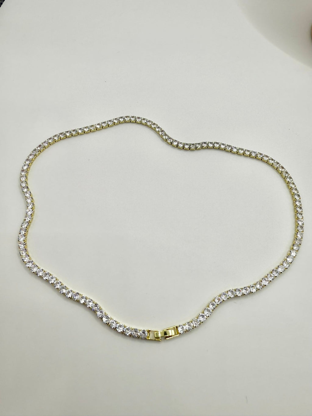 Collana tennis con montatura color oro